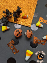 Load image into Gallery viewer, Image showing a pair of spooky pumpkin earrings among confetti, on a glitter background 
